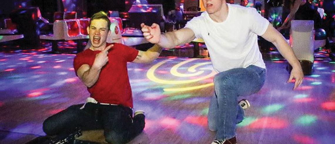 Students bowling under lights